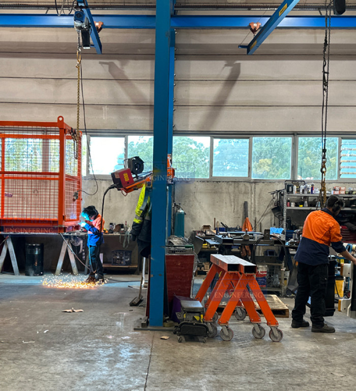 AWB36 Welding Boom Arm Double-Articulated shared between two metal fabrication assembly bays